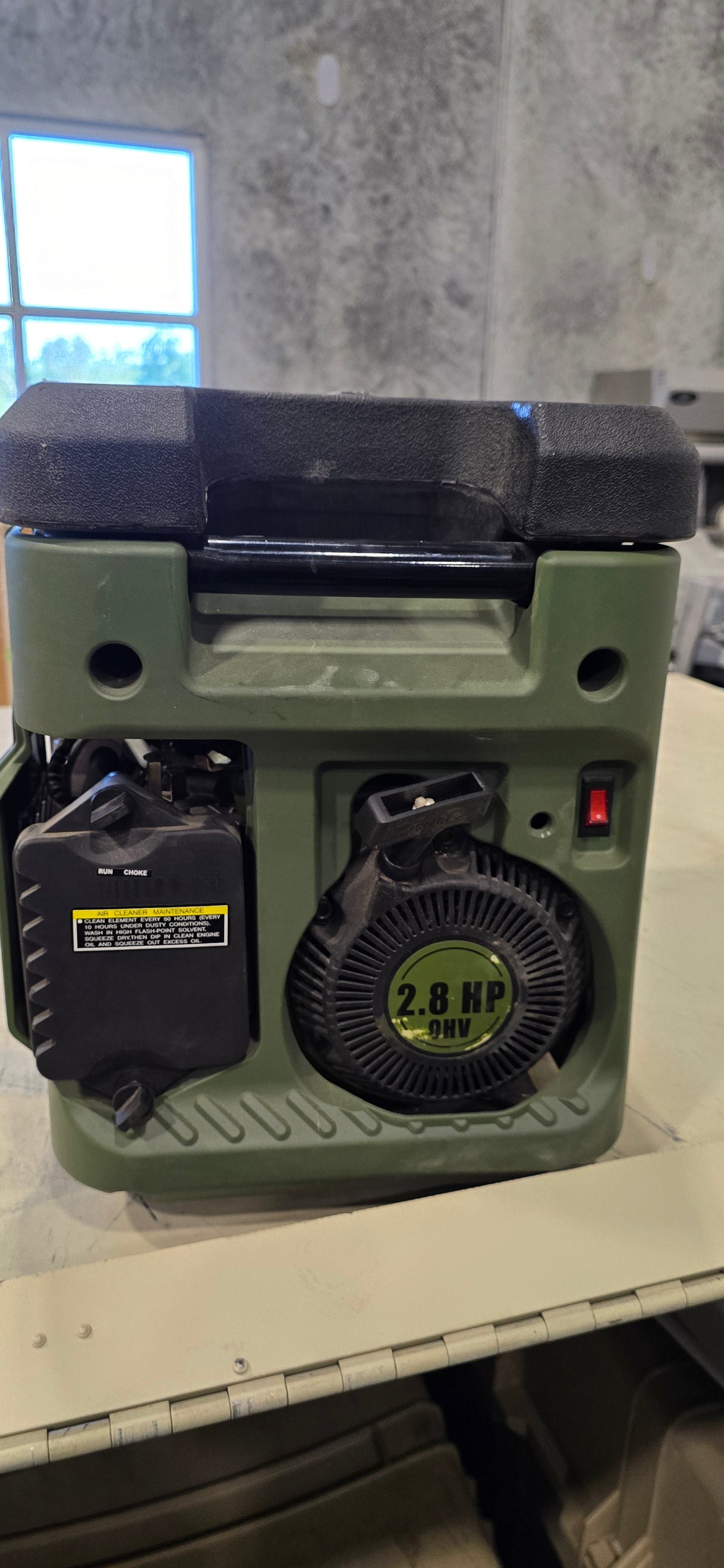 Front view of green Sportsman GEN1850 portable generator showing start pull cord, control panel and 2.8 HP engine.