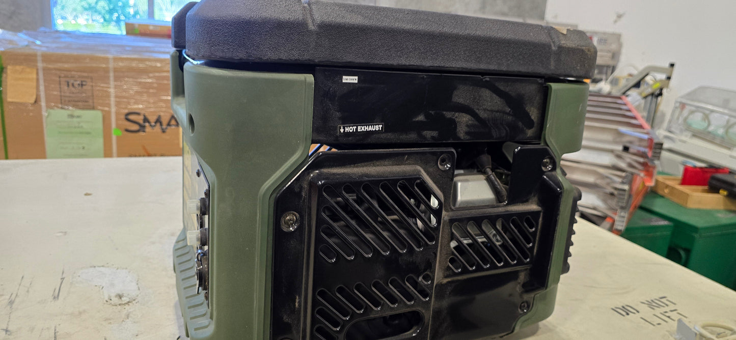 Side view of green and black Sportsman GEN1850 portable generator on workbench with boxes and equipment in background.