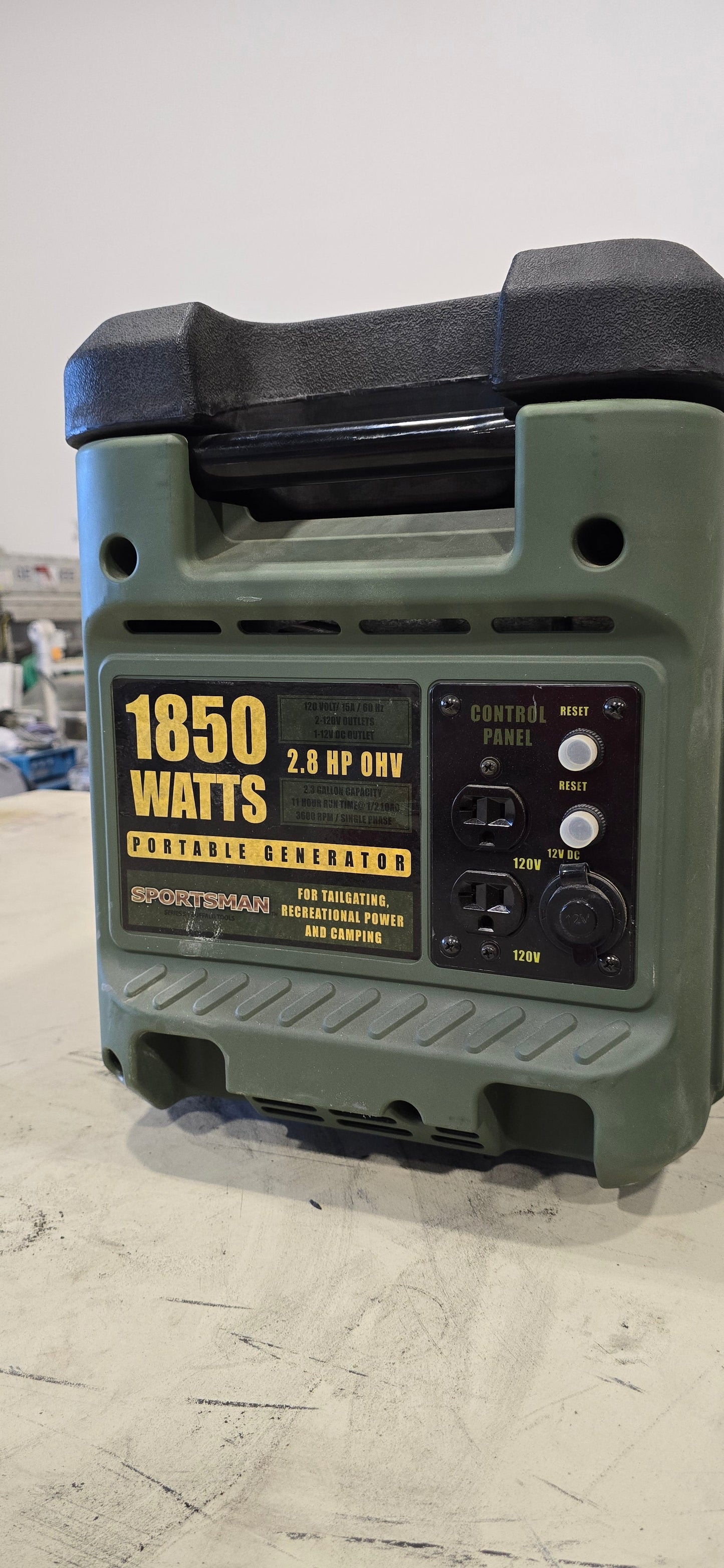 Green Sportsman GEN1850 portable gas generator with 1850 watts capacity and control panel on light gray background.