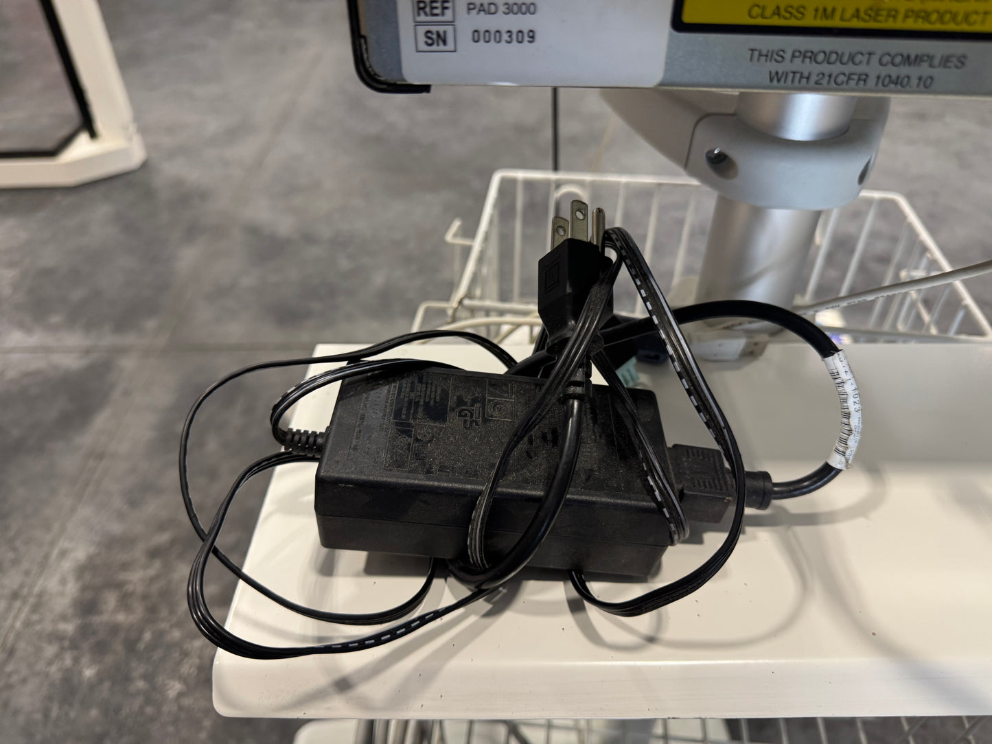 Power adapter with multiple cables for Vasamed SensiLase PAD 3000 resting on equipment tray.