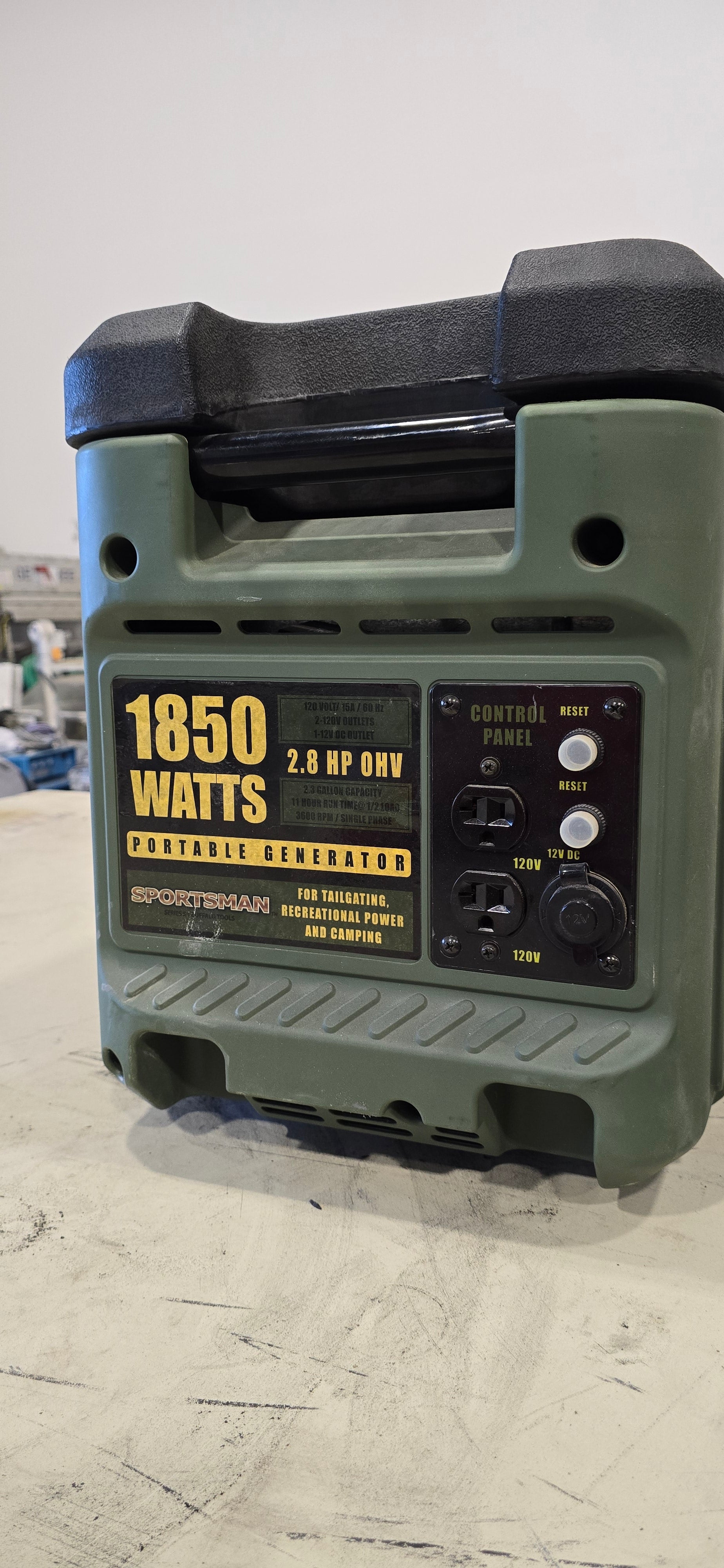 Green Sportsman GEN1850 portable gas generator with 1850 watts capacity and control panel on light gray background.