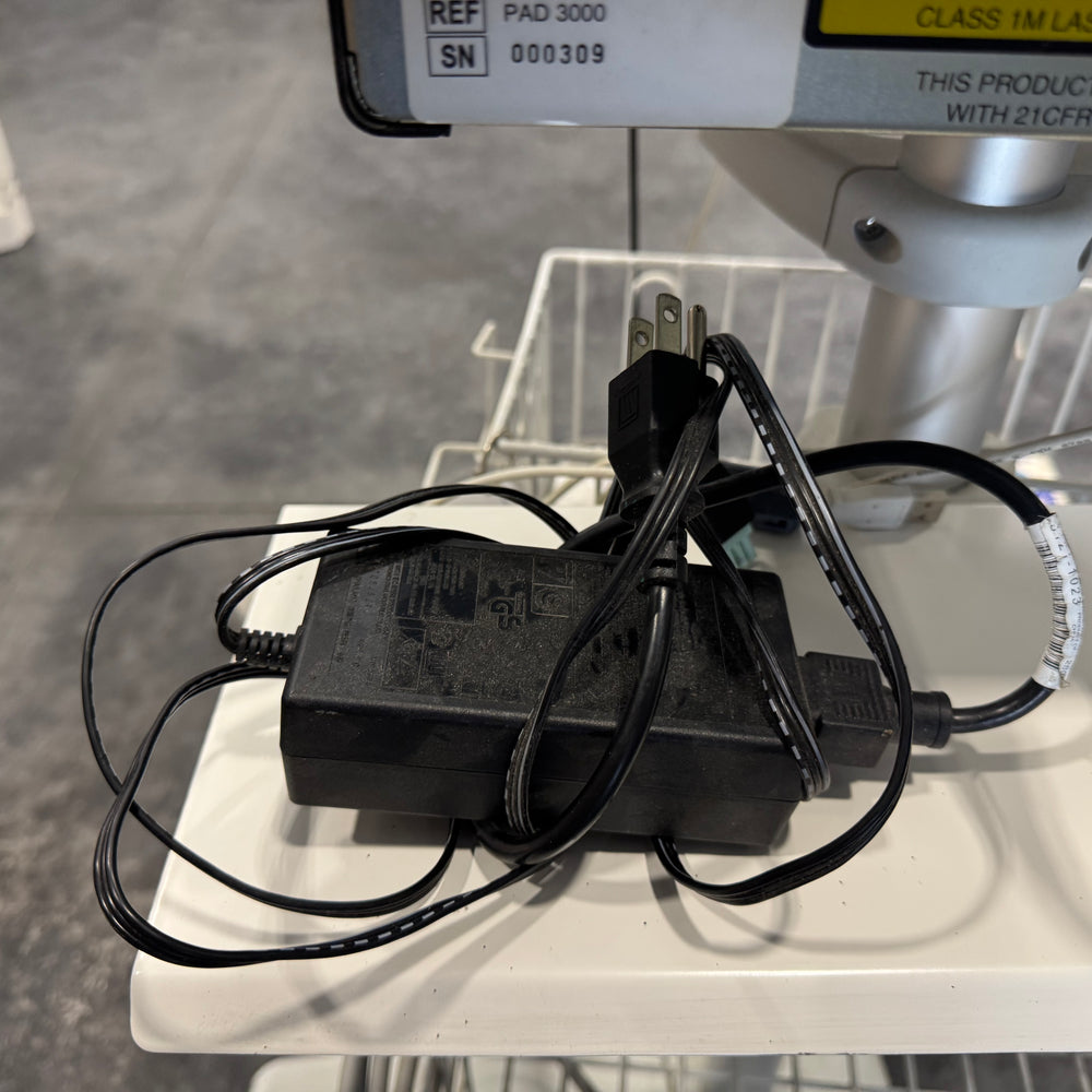 Power adapter with multiple cables for Vasamed SensiLase PAD 3000 resting on equipment tray.